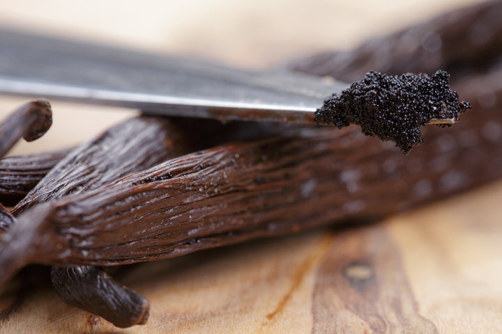 Close up image of Ugandan vanilla beans scraped with caviar on knife