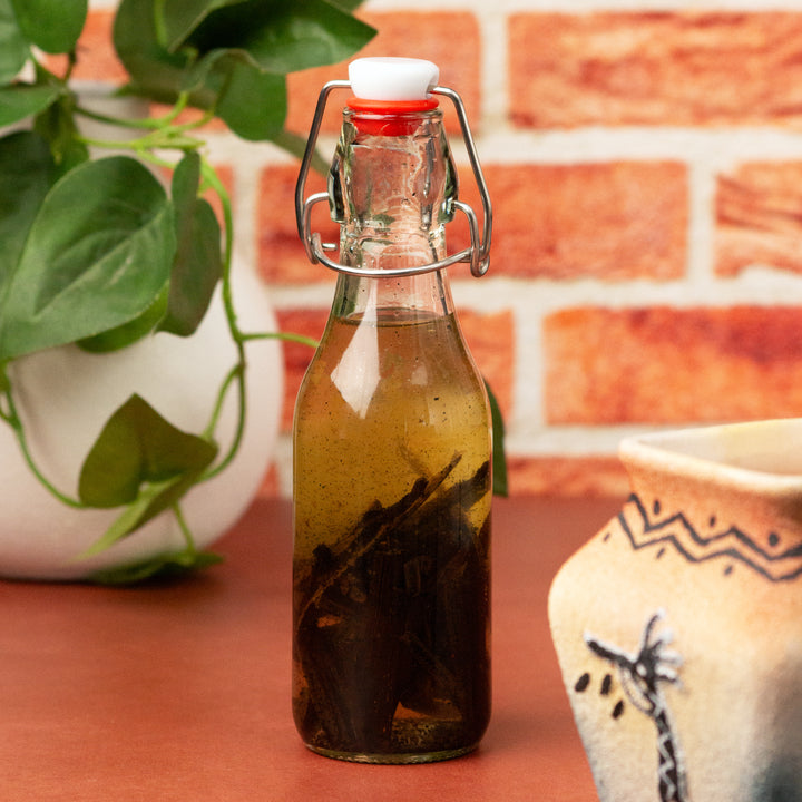 Mexican San Luis Potosi vanilla beans extracting in swing top bottle 