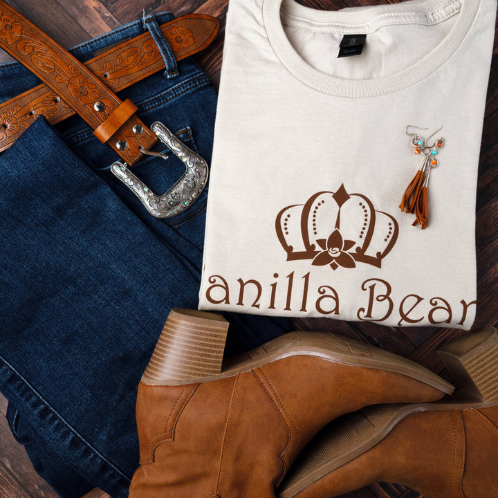 Vanilla Bean Kings logo t-shirt folded up styled against jeans, a belt, and brown boots