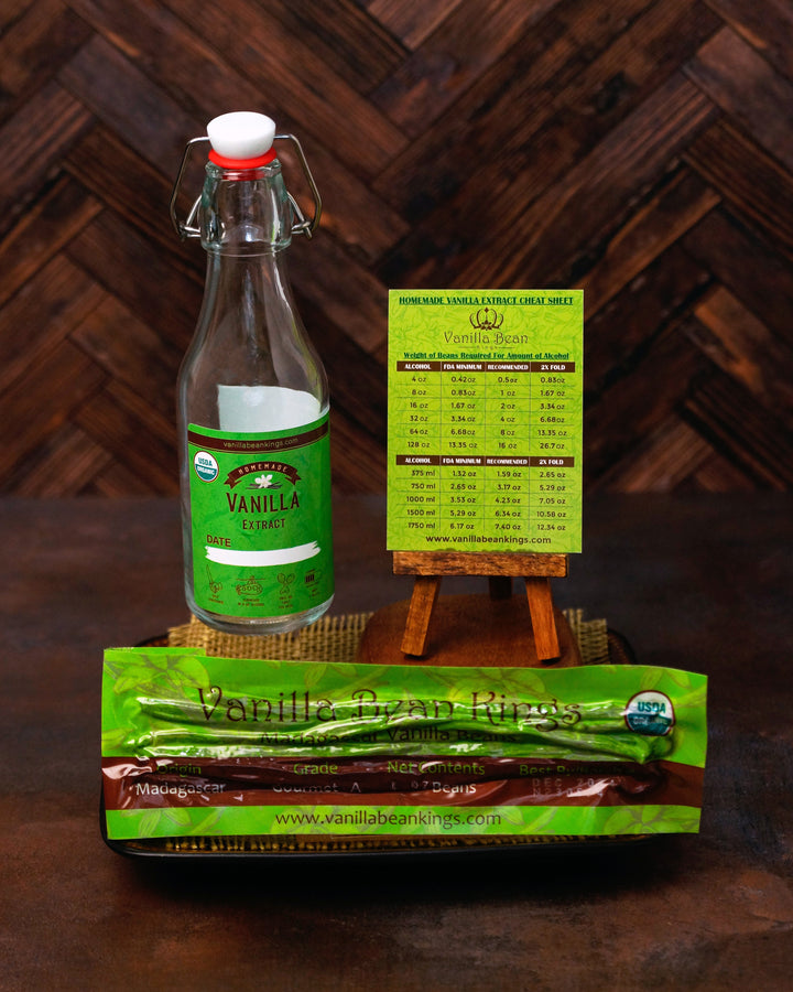Bottle of vanilla extract with packaging and a sign on a wooden background