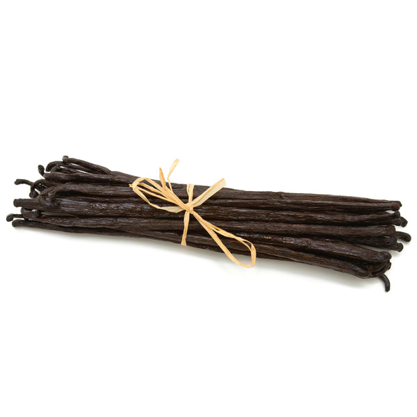 Bunch of vanilla beans tied with a yellow string on a white background