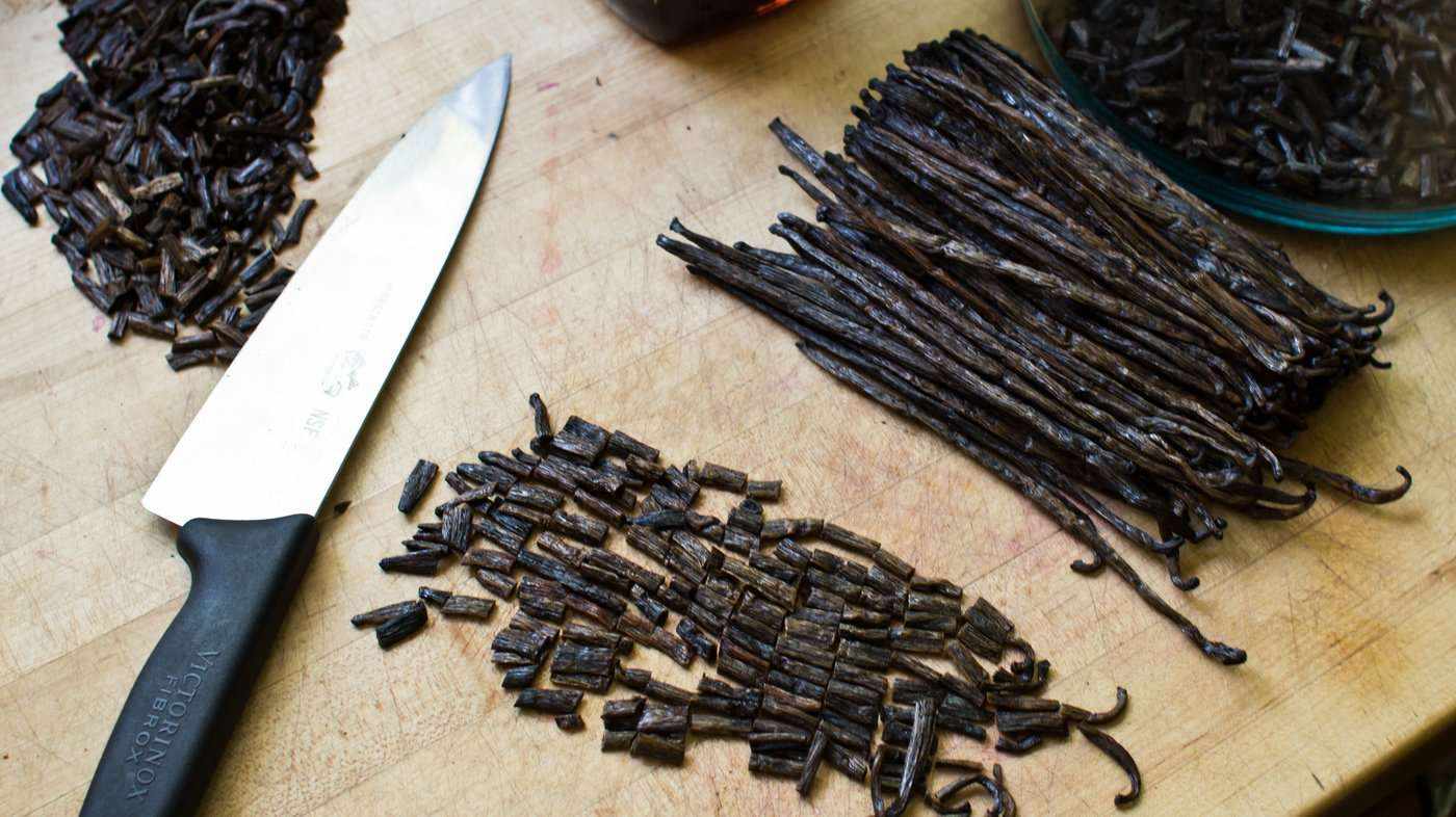 chopped vanilla beans with whole vanilla beans and knife