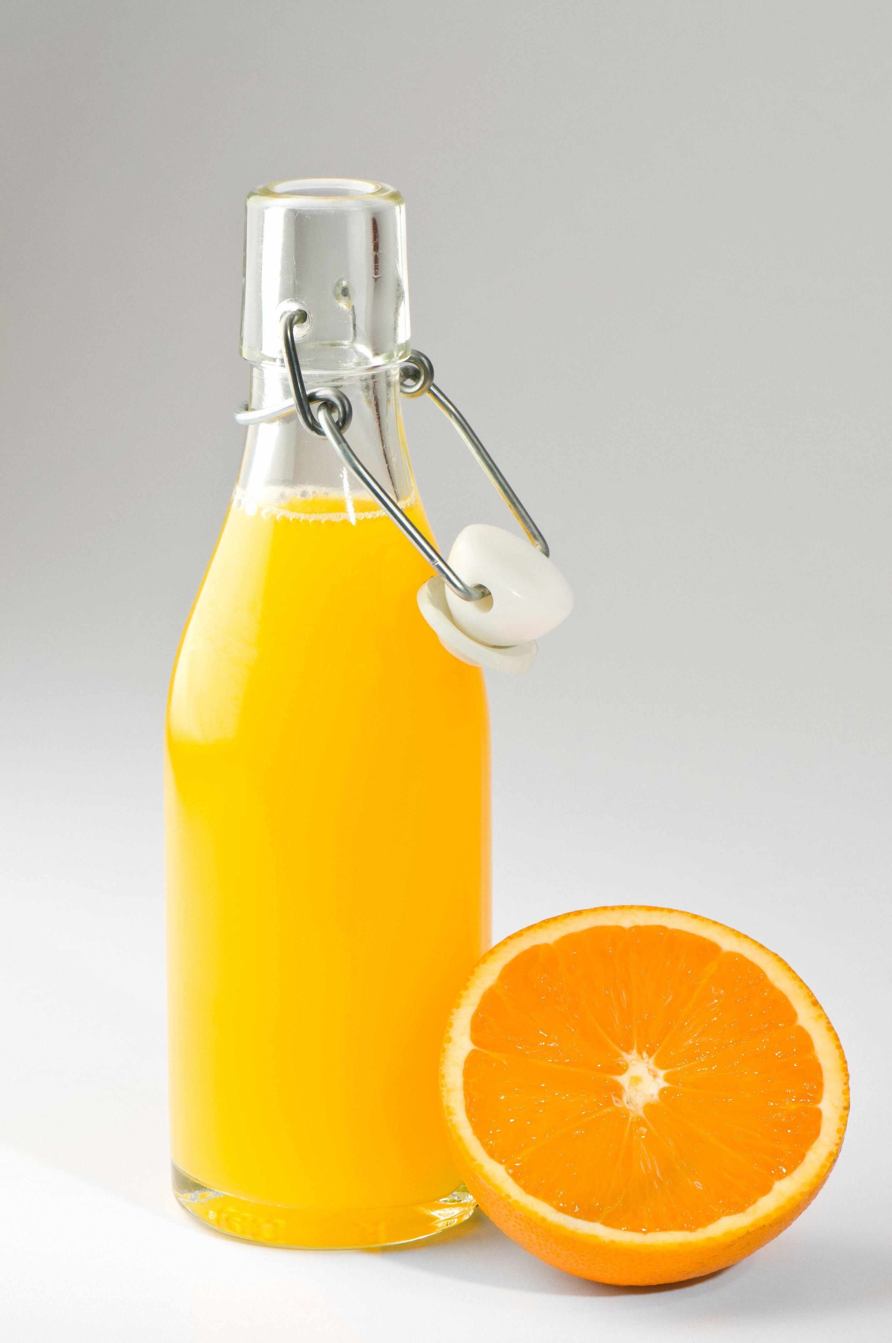 8.5 ounce swing top glass bottle filled with orange juice