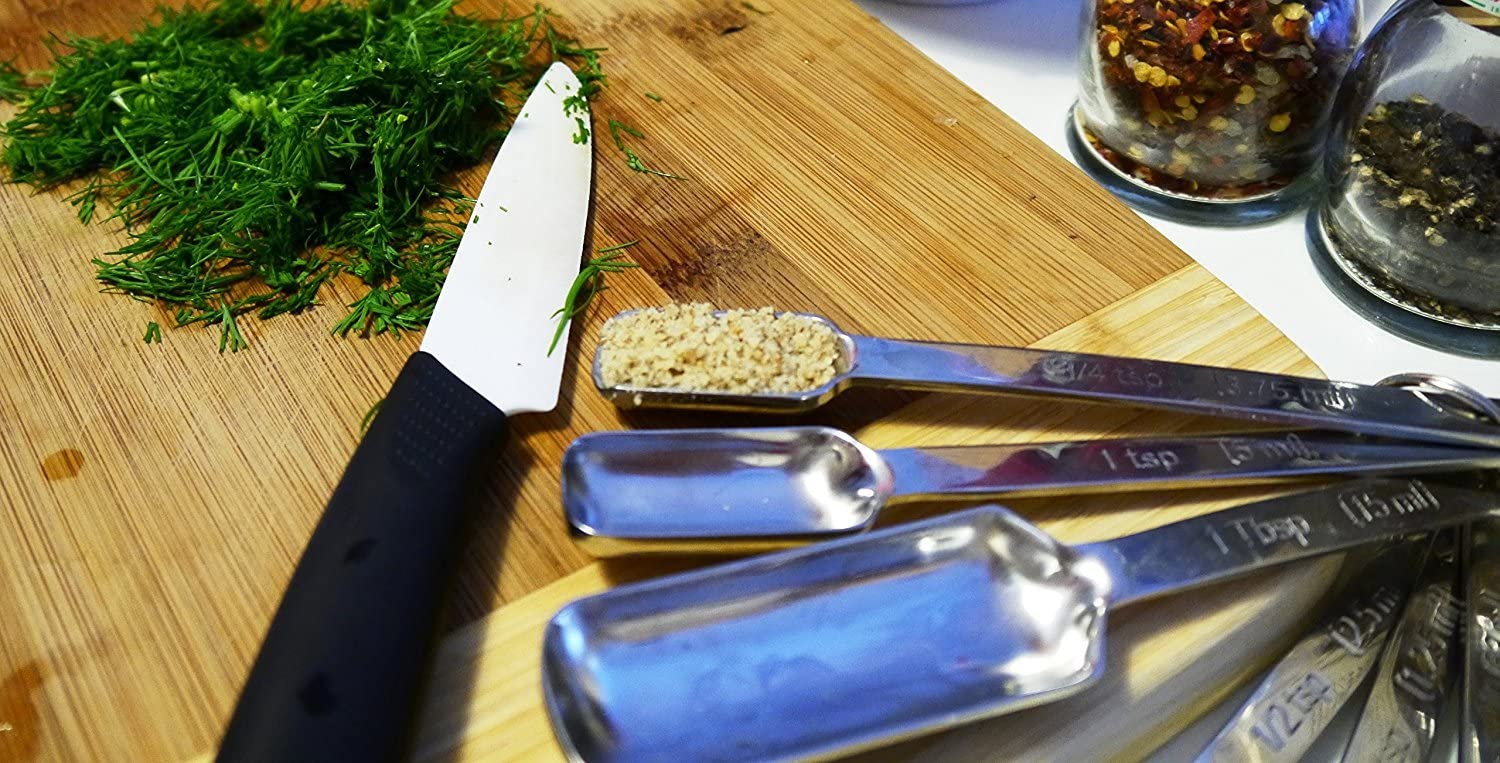 spoon with garlic on cutting board