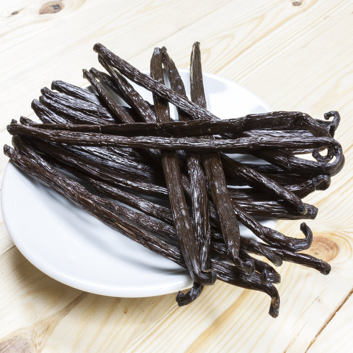 beautiful grade A vanilla beans on white plate 