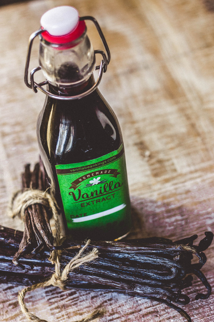 vanilla extract in swing top bottle with vanilla beans on the side