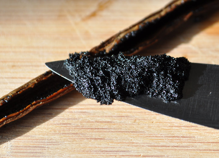 scraped vanilla bean with caviar on knife tip